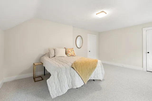 a bedroom with a bed and a table