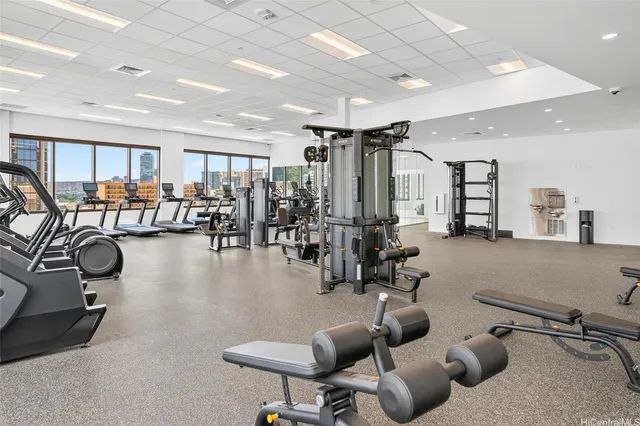 a gym room with lots of gym equipment