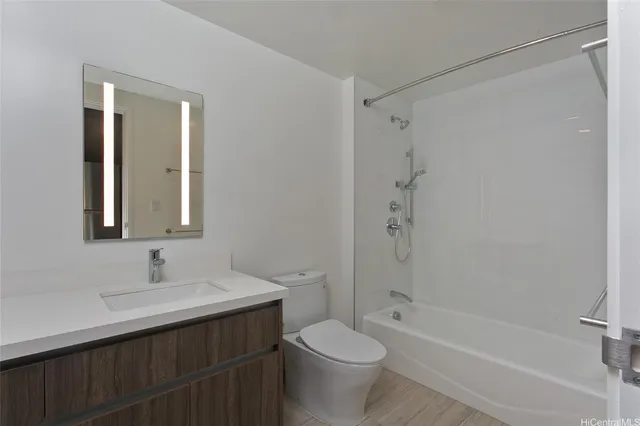 a bathroom with a sink toilet vanity and shower