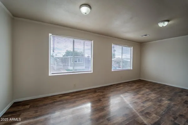 wooden floor in an empty room with a window