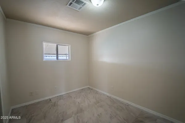 an empty room with closet area