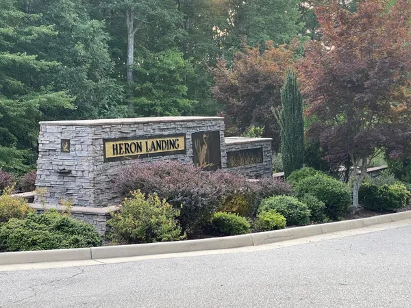 a view of a street sign under a large tree