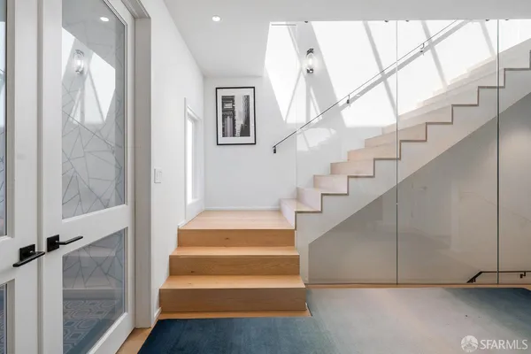 a view of entryway and hall with wooden floor