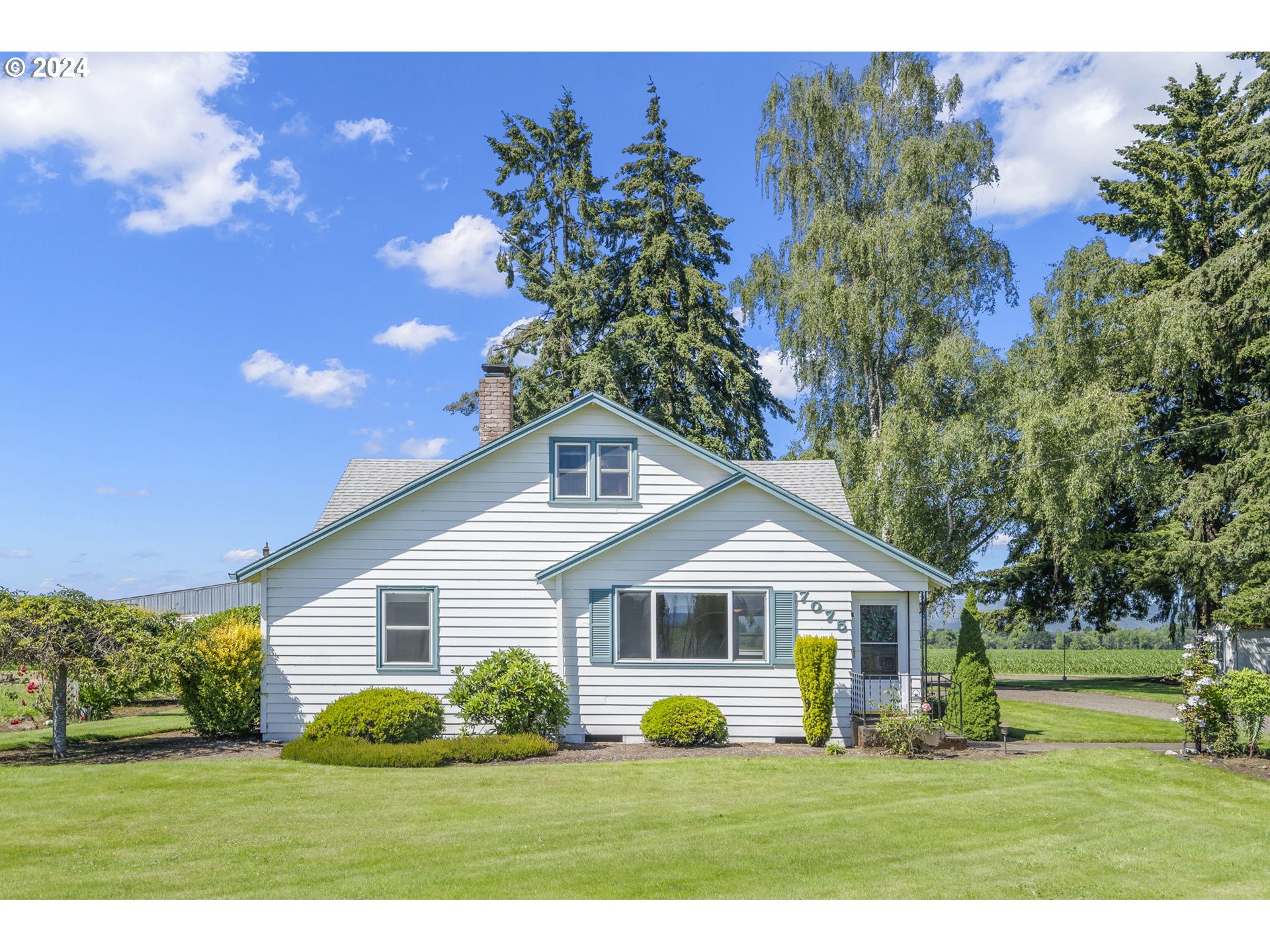 7075 Northwest Roy Road Cornelius, OR 97113 - Photo 1 of 48 a front view of a house with garden and trees