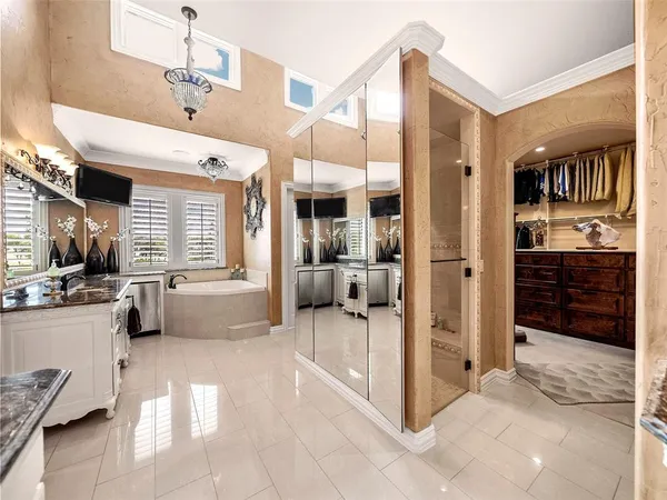 a very nice looking dining room with a large window and chandelier