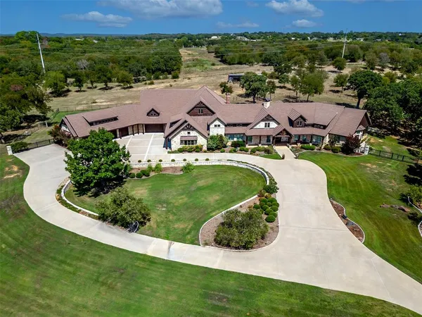 an aerial view of a house with garden space and lake view