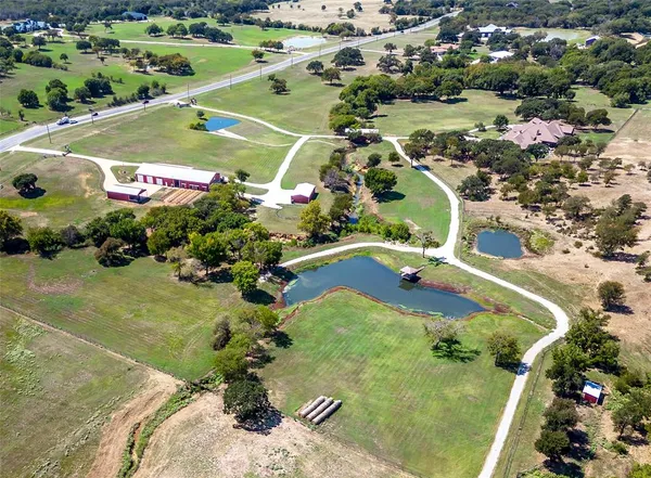 an aerial view of residential houses with outdoor space and river