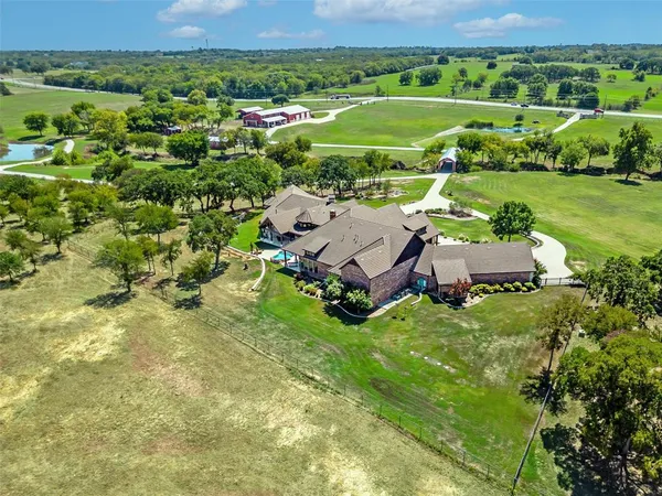 a view of a field with grass and trees