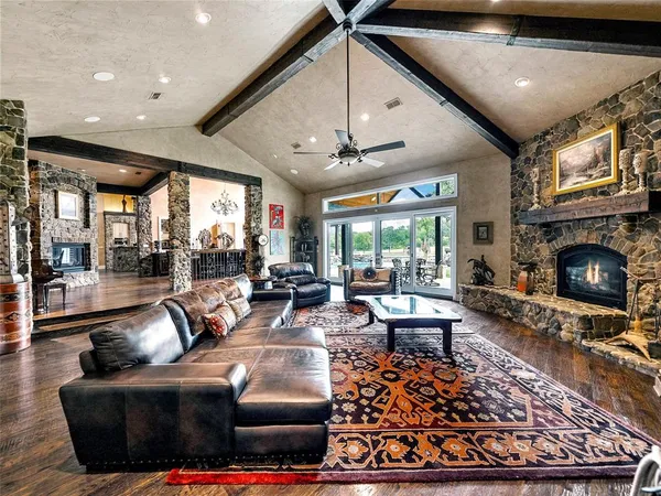 a living room with furniture a fireplace and a flat screen tv