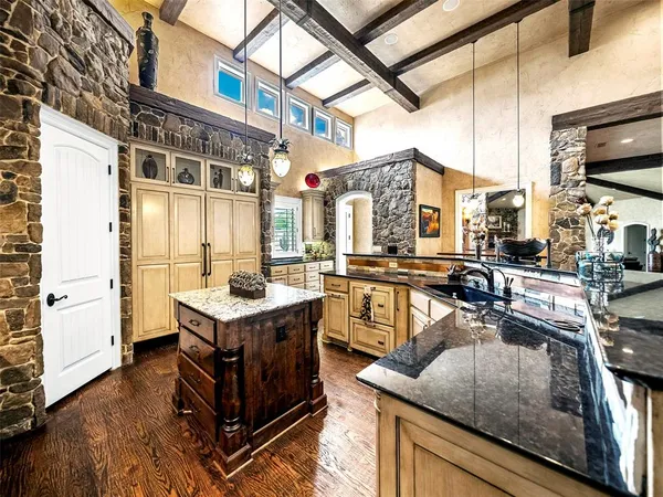 a kitchen with a stove a refrigerator and wooden floor