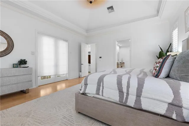 a spacious bedroom with a bed and a dresser