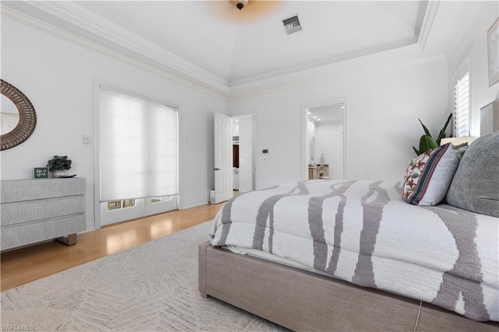 505 Harbour Drive Naples, FL 34103 - Photo 22 of 34 a spacious bedroom with a bed and a dresser