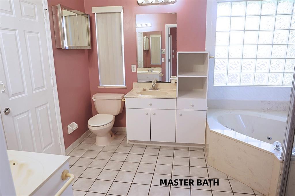 242 Southwest Parish Terrace Port St. Lucie, FL 34984 - Photo 6 of 14 a bathroom with a sink a toilet and mirror