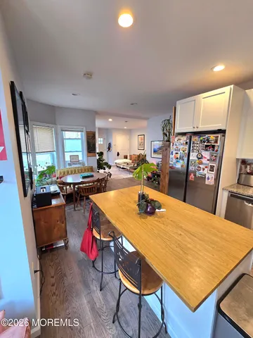 a room with furniture a rug and a view of kitchen