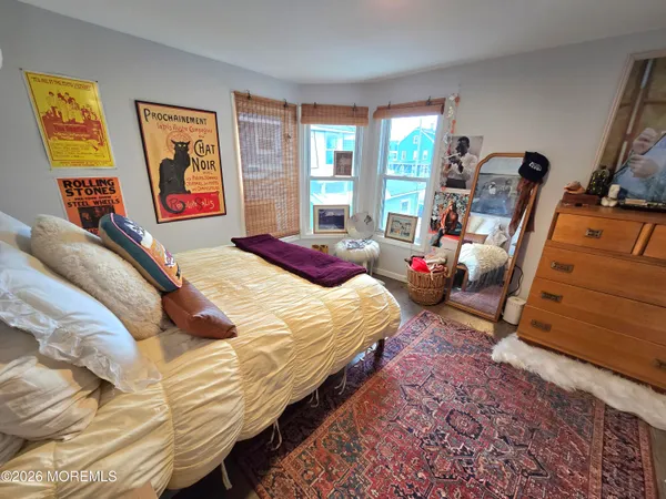 a bed sitting in a bedroom next to a window