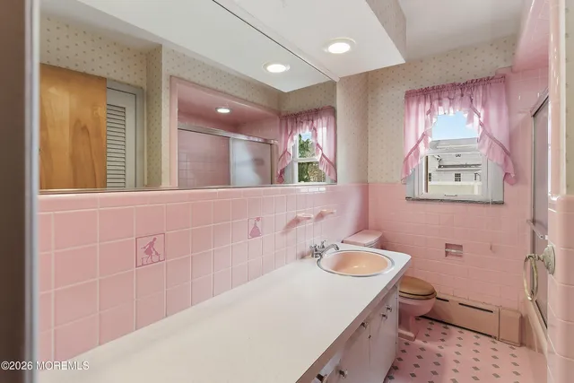 a bathroom with a sink a vanity and a mirror