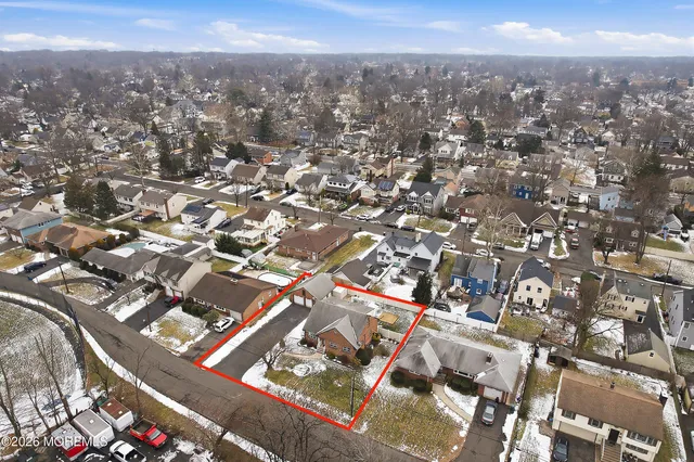 an aerial view of residential building with parking