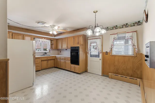 a kitchen with refrigerator a sink and cabinets