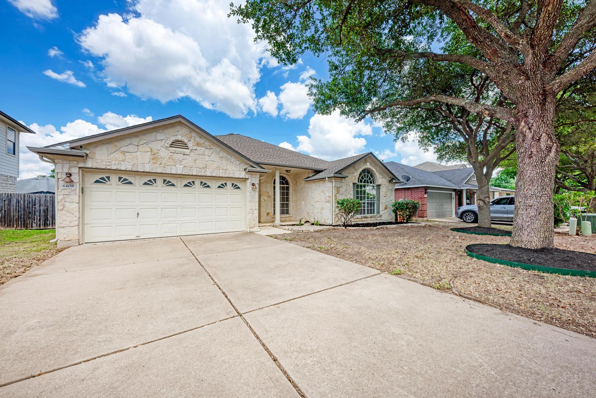 4408 Tello Path Austin, TX 78749 - Photo 1 of 38 Ranch-style house with concrete driveway, stone siding, a garage, and a shingled roof