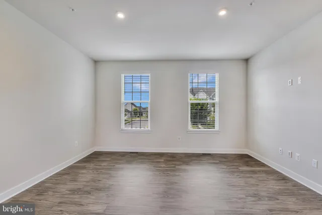 a view of kitchen and hall with wooden floor