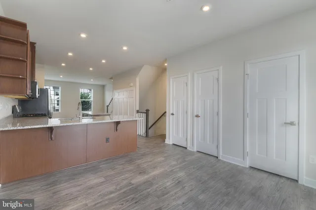 a kitchen with cabinets and wooden floors
