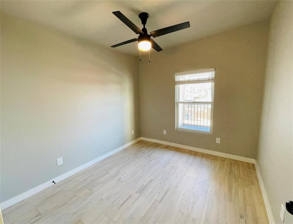 4609 Virginia Avenue, Unit 202 Dallas, TX 75204 - Photo 12 of 21 an empty room with wooden floor and windows