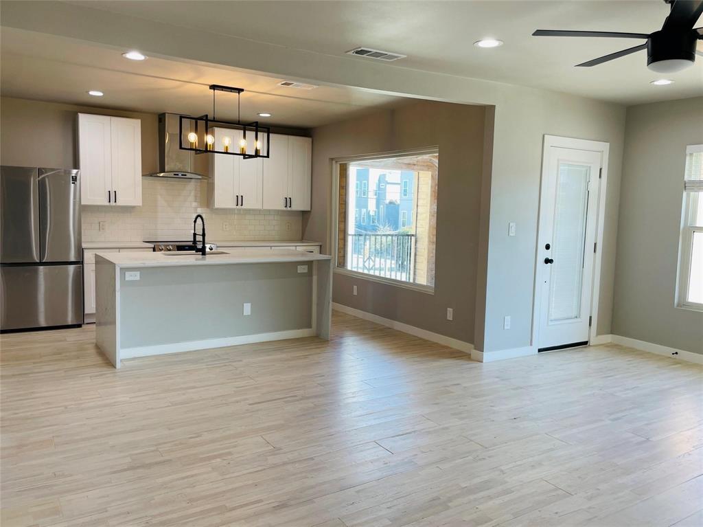 4609 Virginia Avenue, Unit 202 Dallas, TX 75204 - Photo 2 of 21 a large kitchen with stainless steel appliances granite countertop a refrigerator and a sink