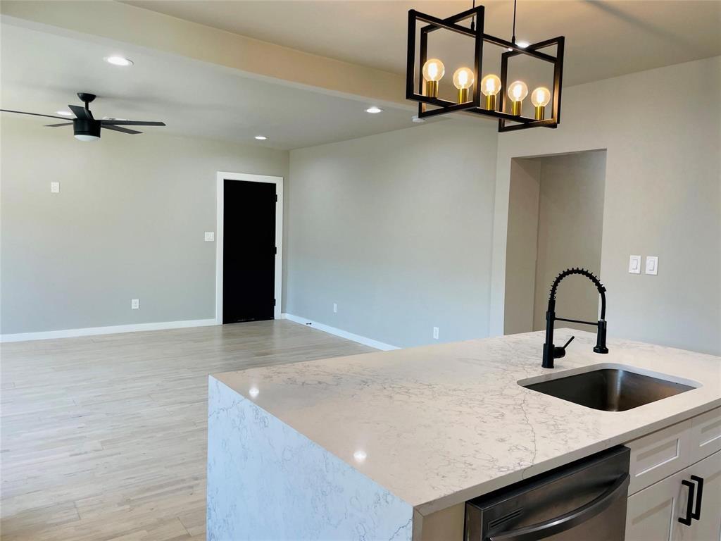 4609 Virginia Avenue, Unit 202 Dallas, TX 75204 - Photo 6 of 21 a kitchen with a sink a counter space and cabinets