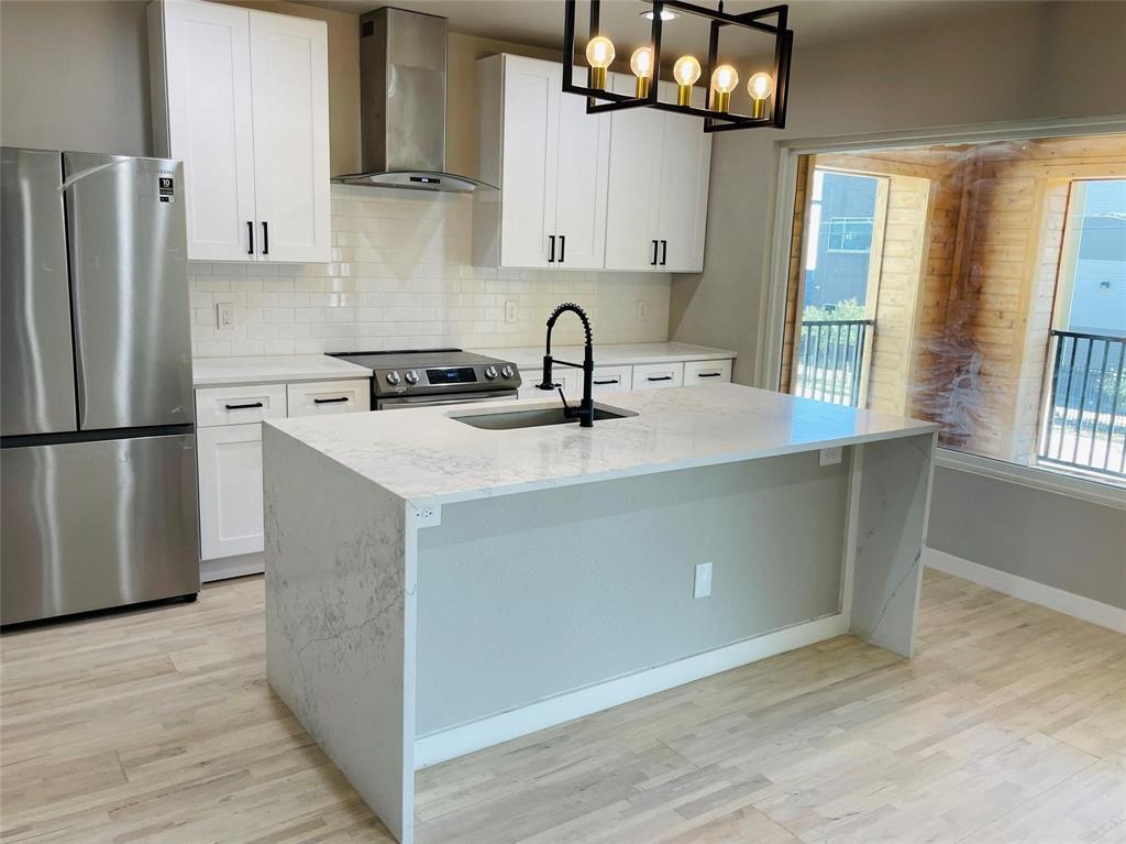 4609 Virginia Avenue, Unit 202 Dallas, TX 75204 - Photo 7 of 21 a kitchen with stainless steel appliances granite countertop a sink dishwasher a refrigerator and a stove with wooden floor