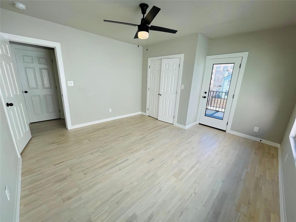 4609 Virginia Avenue, Unit 202 Dallas, TX 75204 - Photo 9 of 21 an empty room with wooden floor and ceiling fan