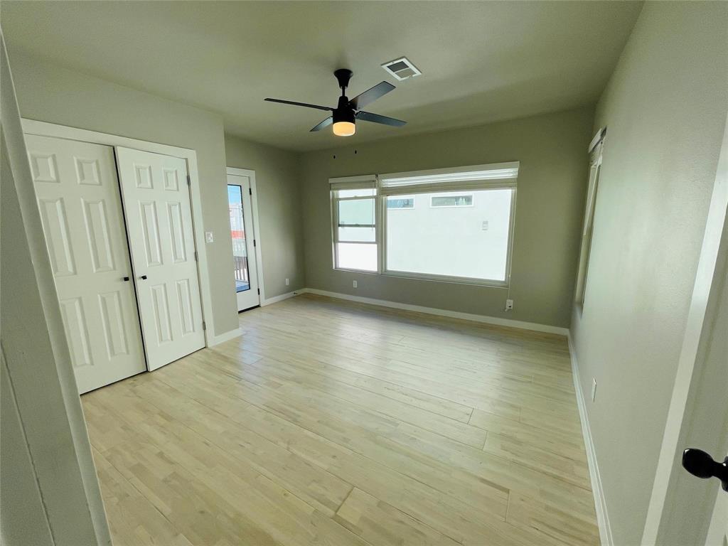 4609 Virginia Avenue, Unit 202 Dallas, TX 75204 - Photo 10 of 21 wooden floor in an empty room with a window
