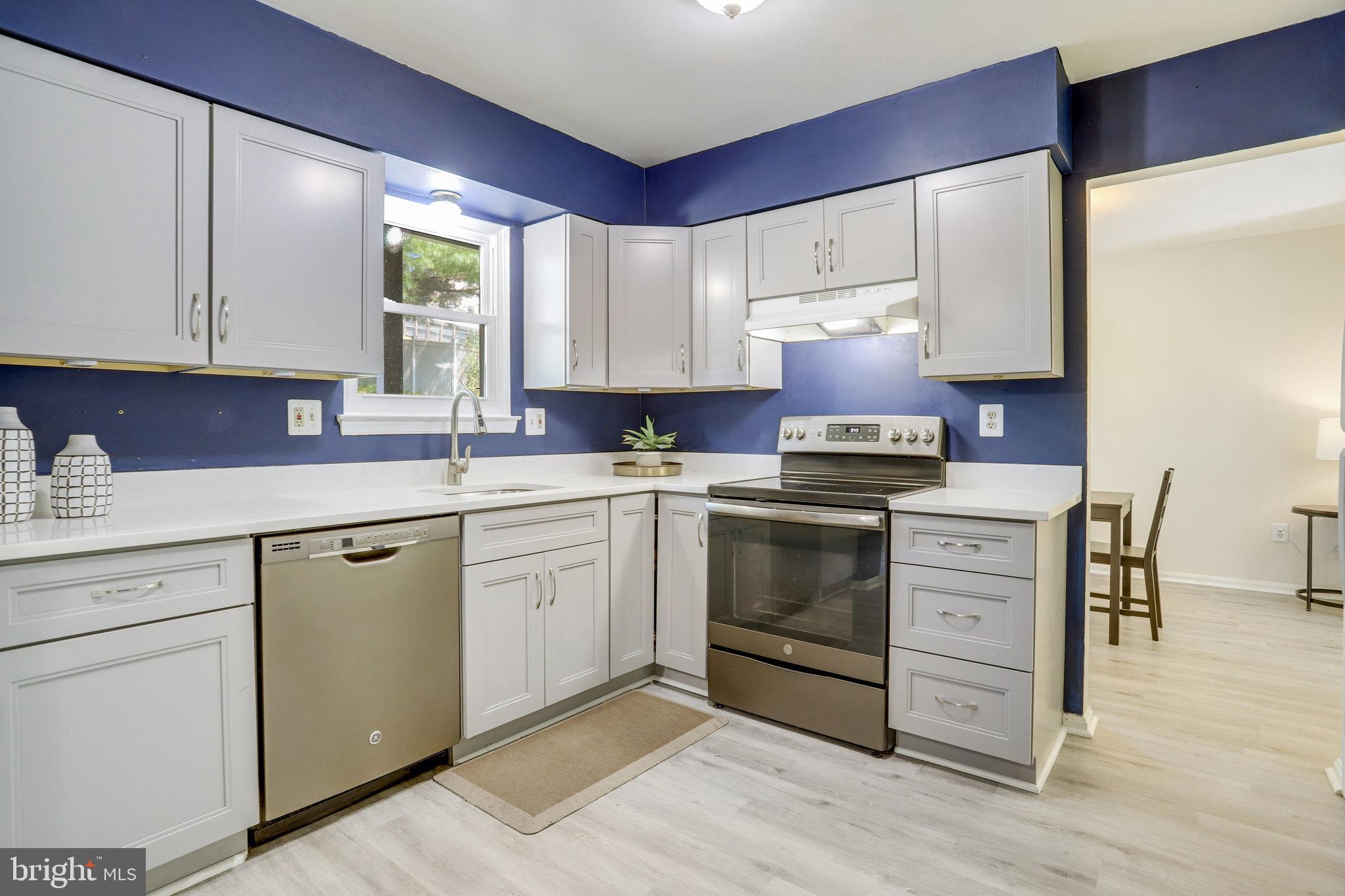 6903 Cherryfield Road Fort Washington, MD 20744 - Photo 14 of 58 a kitchen with granite countertop white cabinets and white appliances