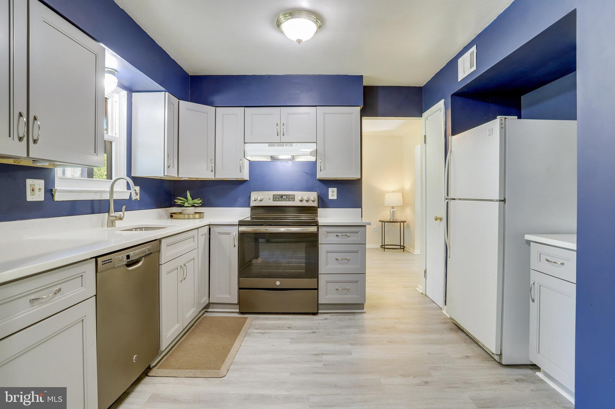 6903 Cherryfield Road Fort Washington, MD 20744 - Photo 15 of 58 a kitchen with a refrigerator and a sink