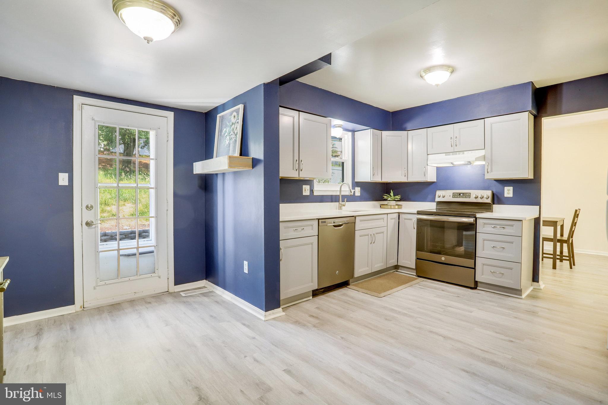 6903 Cherryfield Road Fort Washington, MD 20744 - Photo 18 of 58 a kitchen with stainless steel appliances granite countertop a stove sink and cabinets