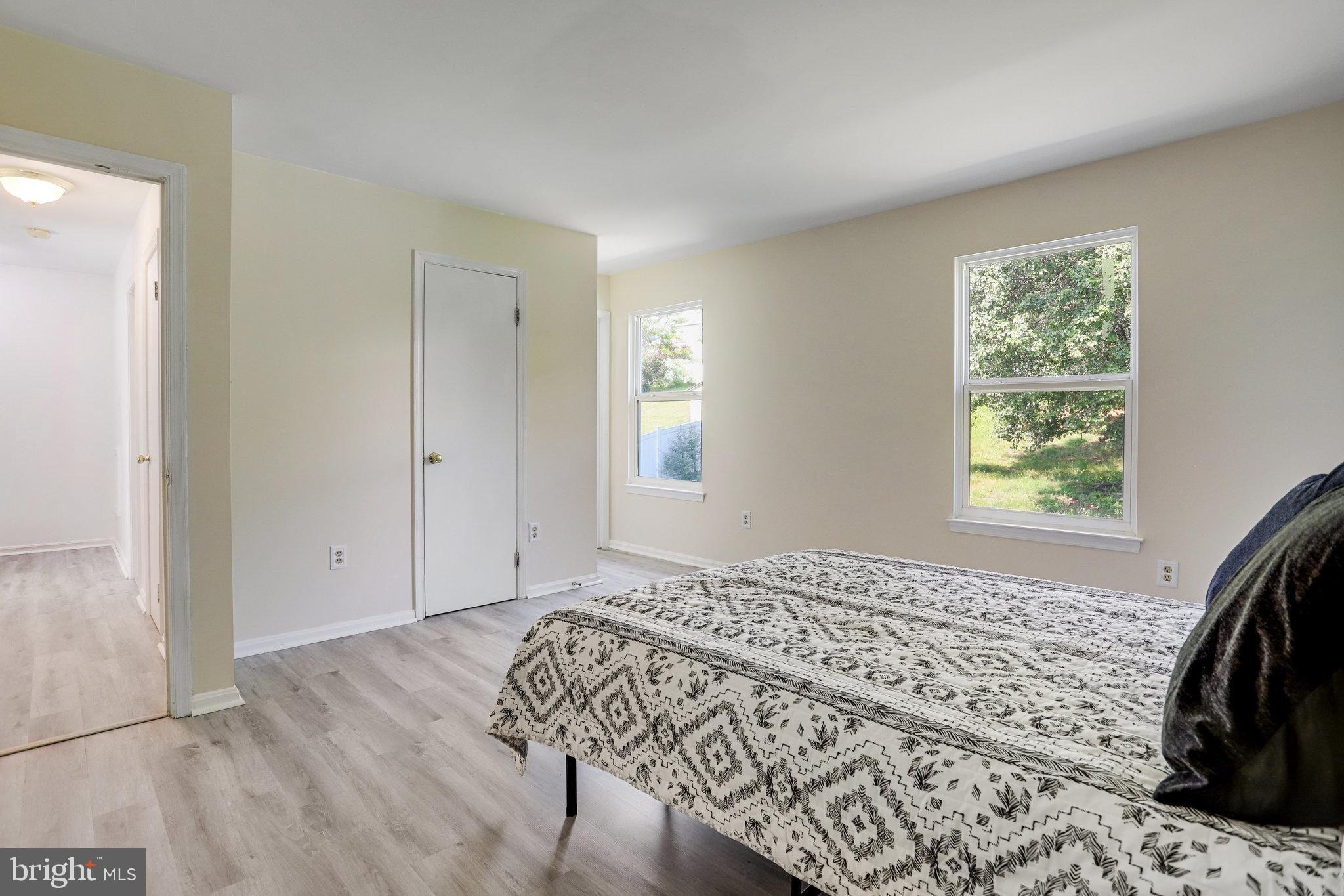 6903 Cherryfield Road Fort Washington, MD 20744 - Photo 36 of 58 a view of a bedroom with a bed and wooden floor