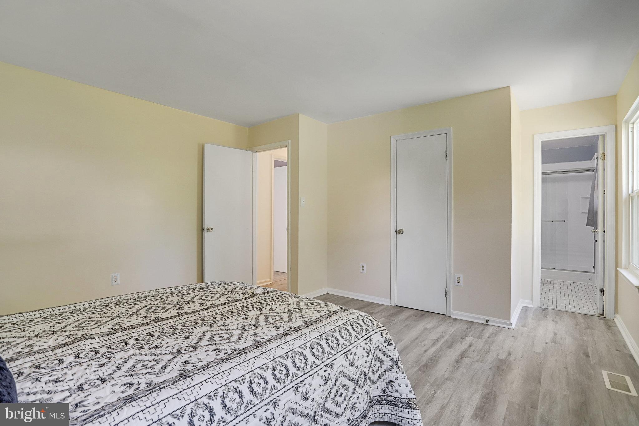6903 Cherryfield Road Fort Washington, MD 20744 - Photo 38 of 58 a view of a bedroom with wooden floor and bathroom