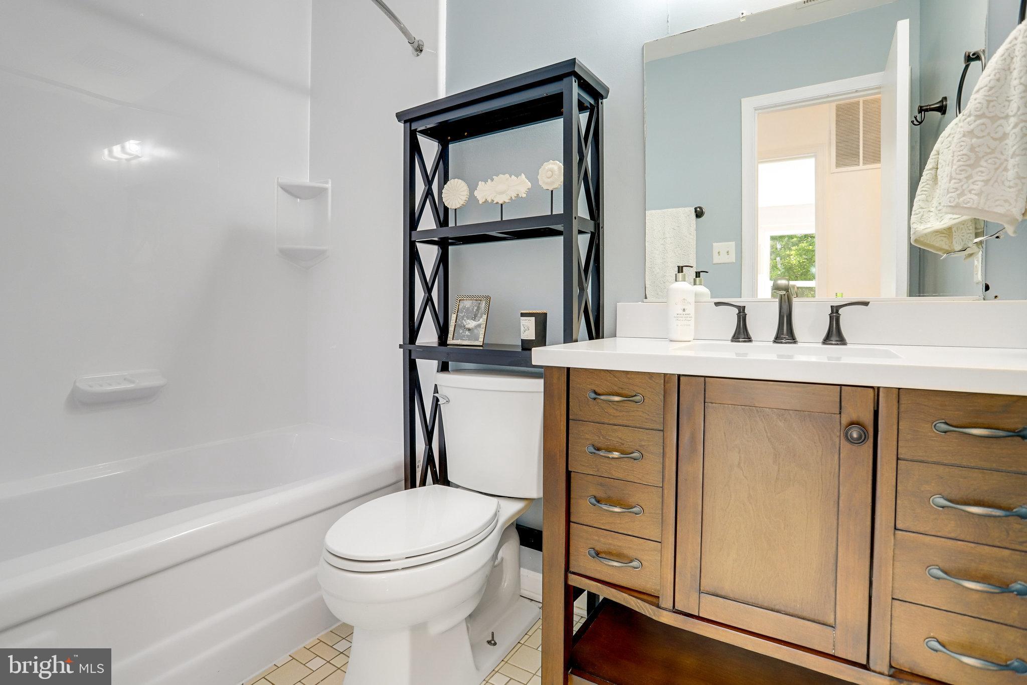 6903 Cherryfield Road Fort Washington, MD 20744 - Photo 42 of 58 a bathroom with a toilet a sink and mirror
