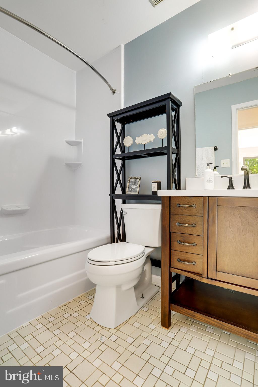 6903 Cherryfield Road Fort Washington, MD 20744 - Photo 43 of 58 a bathroom with a toilet a sink and mirror