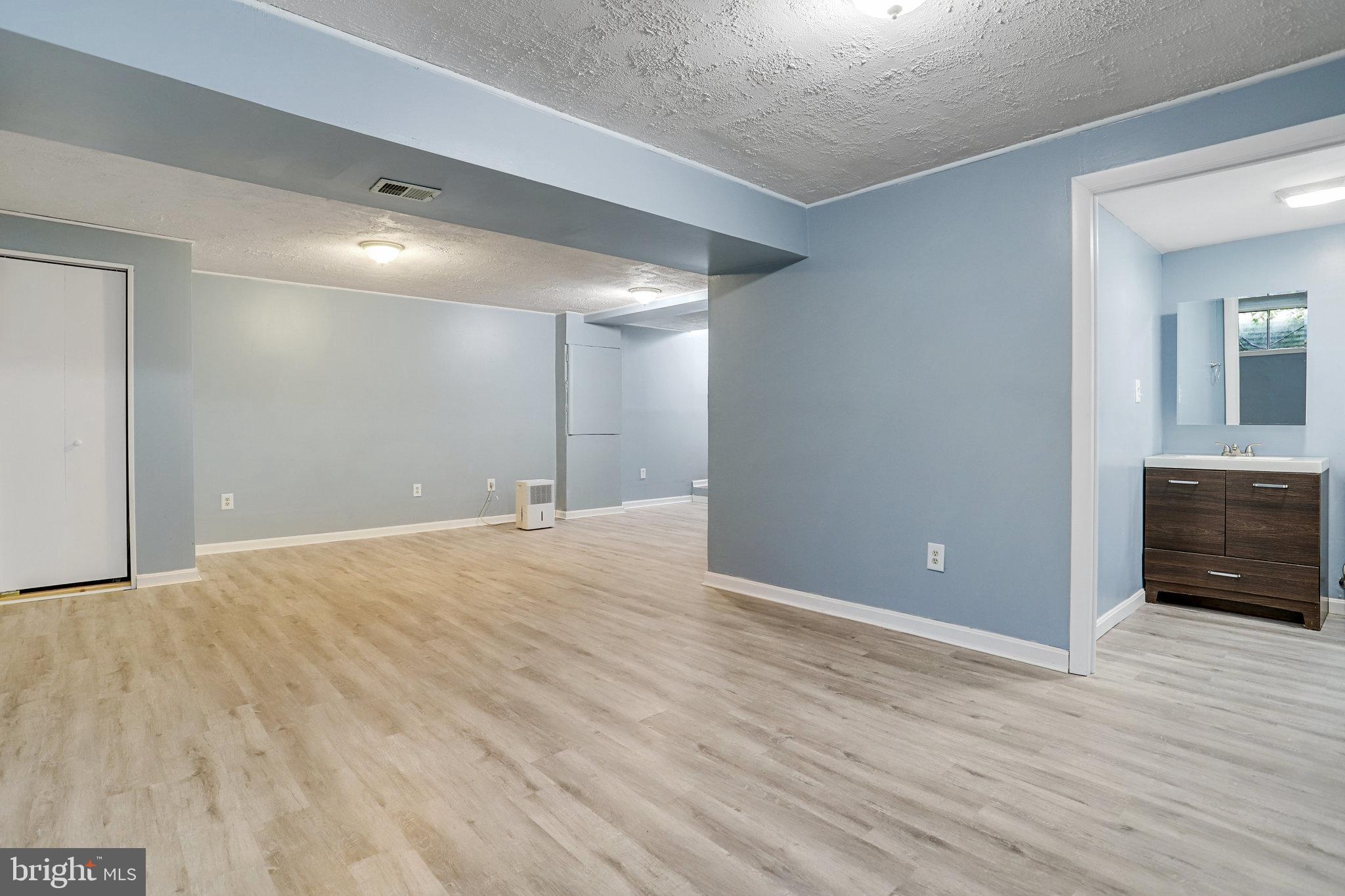 6903 Cherryfield Road Fort Washington, MD 20744 - Photo 45 of 58 a view of an empty room with wooden floor and a window