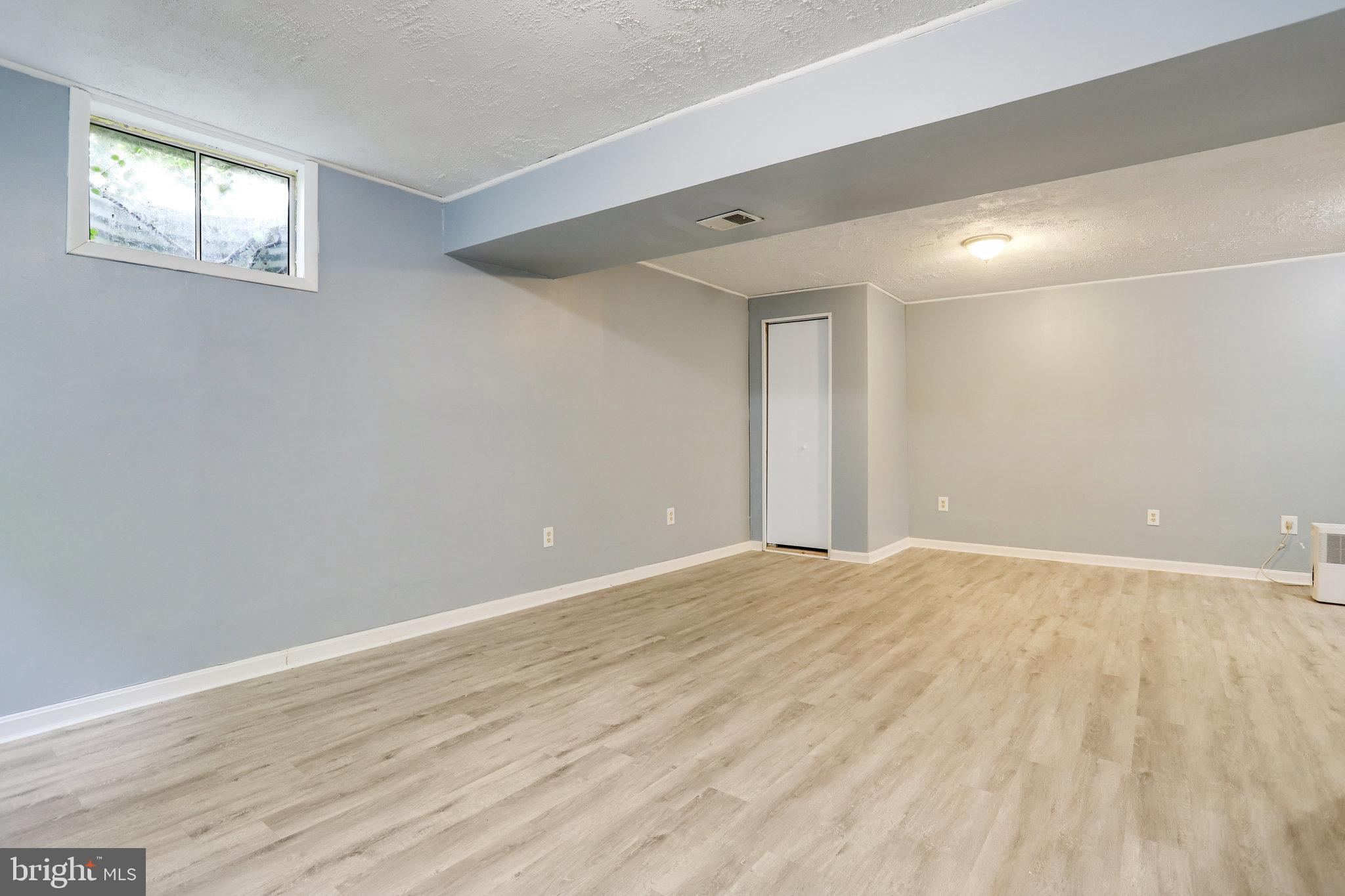 6903 Cherryfield Road Fort Washington, MD 20744 - Photo 46 of 58 a view of an empty room with wooden floor and a window