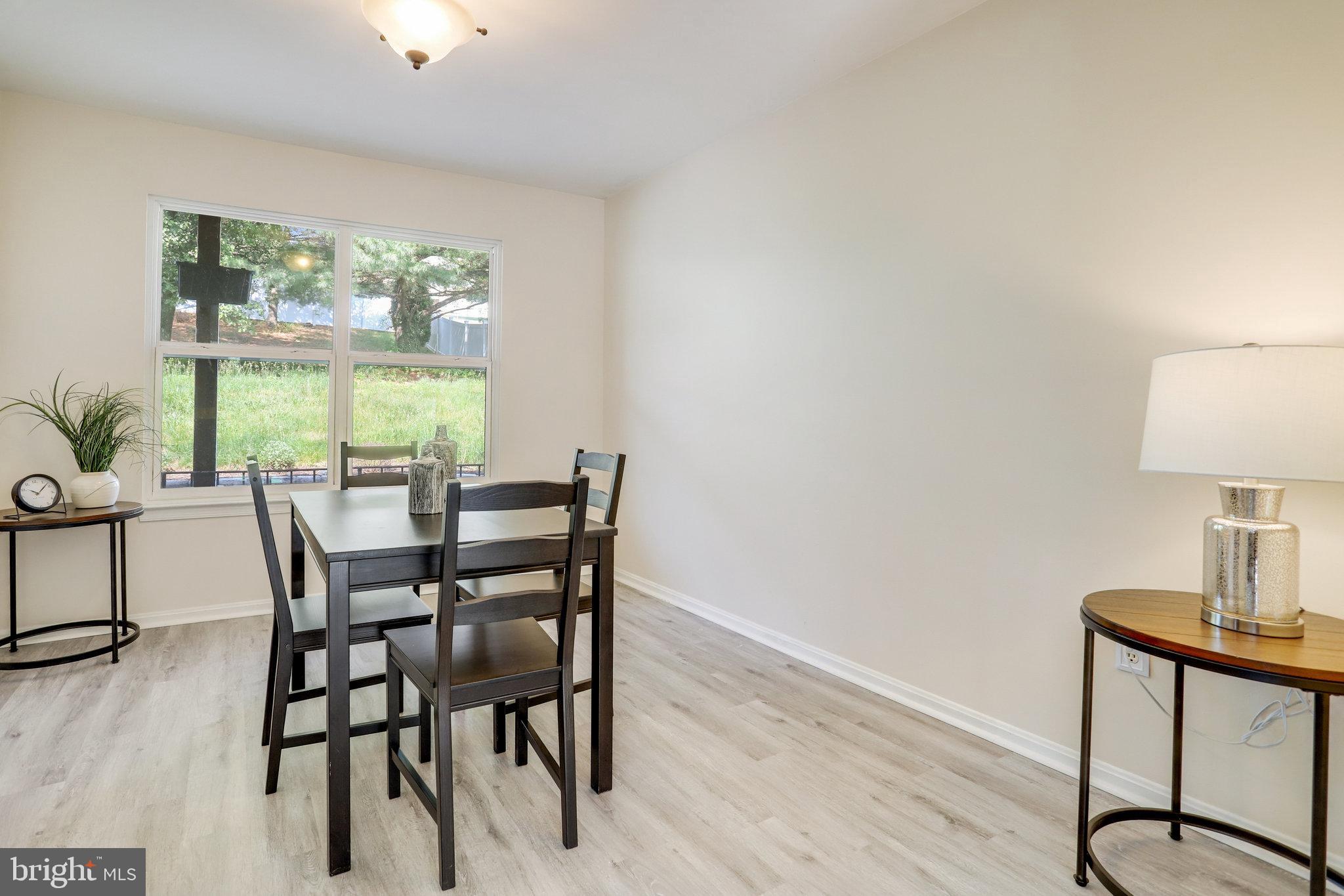 6903 Cherryfield Road Fort Washington, MD 20744 - Photo 8 of 58 a view of a dining room with furniture window and wooden floor