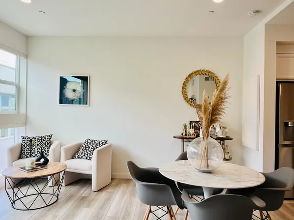 a view of a dining room with furniture and wooden floor