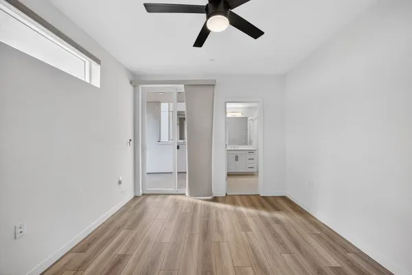 a view of empty room with wooden floor