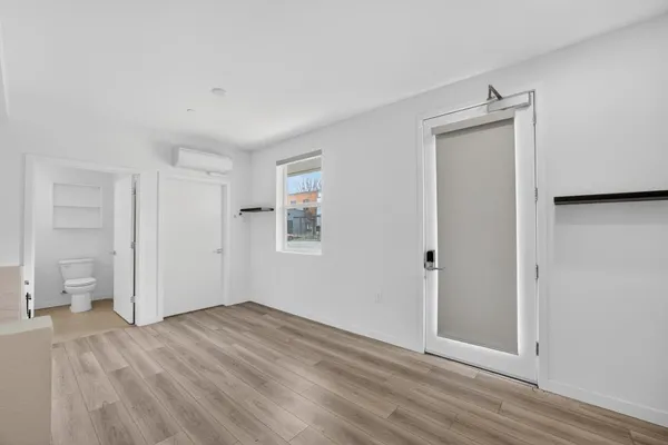 a view of empty room with wooden floor and cabinet