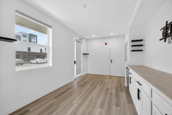 a view of a kitchen with wooden floor
