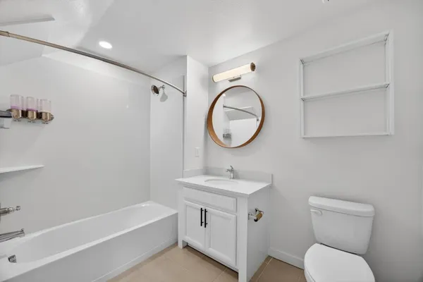 a bathroom with a toilet sink and a mirror
