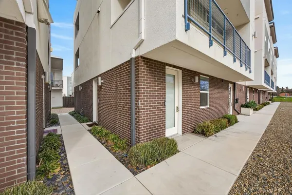 a view of a pathway both side of house