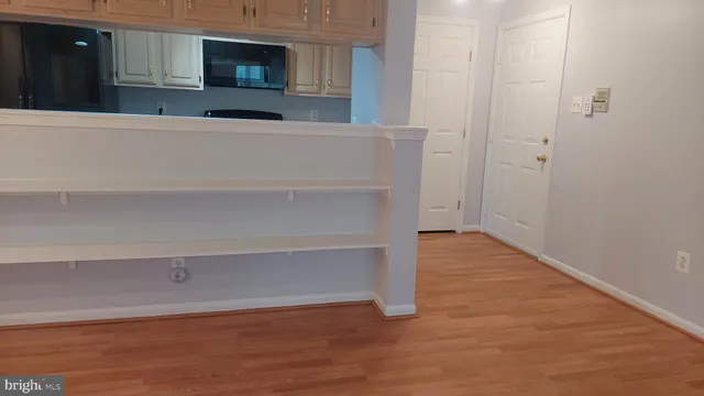 a view of a room with wooden floors and cabinet