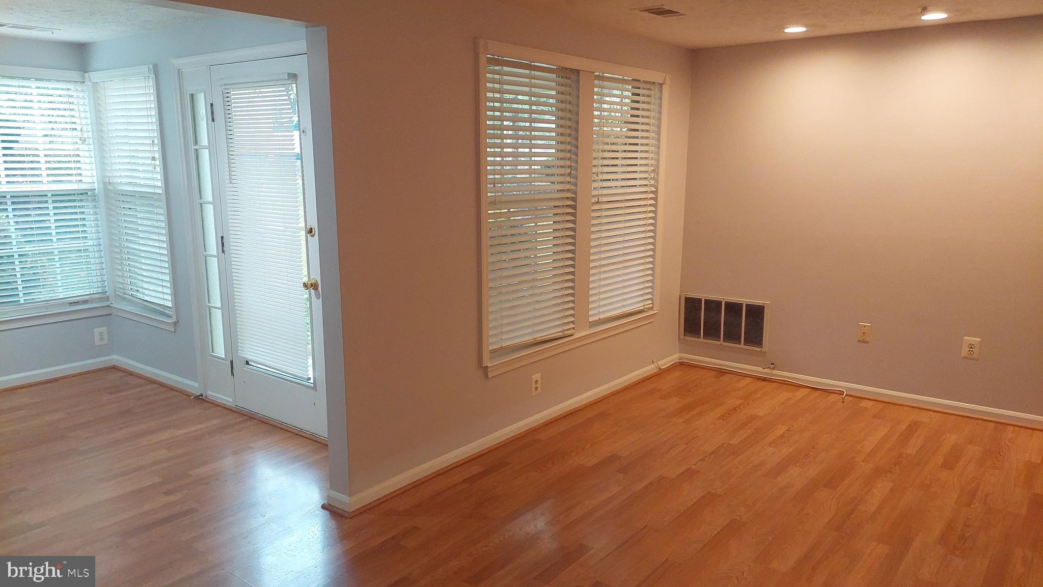 13107 Briarcliff Terrace, Unit 2203 Germantown, MD 20874 - Photo 15 of 53 an empty room with wooden floor and windows