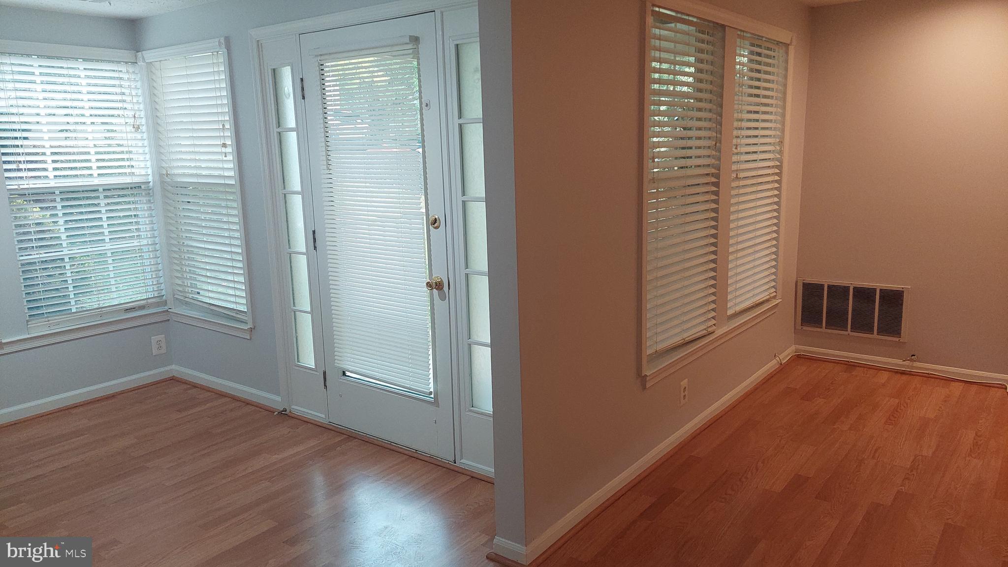 13107 Briarcliff Terrace, Unit 2203 Germantown, MD 20874 - Photo 16 of 53 a view of an empty room with wooden floor and a window